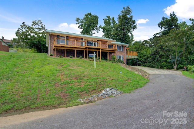 6294 Southlake Dr, Hickory, NC 28601 - ranch-style house with a front yard, a wooden deck, brick siding, and asphalt driveway