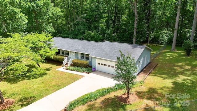 144 Stoneybrook Rd, Salisbury, NC 28147 - ranch-style home featuring a shingled roof, a garage, driveway, and a wooded view