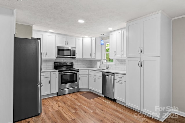 144 Stoneybrook Rd, Salisbury, NC 28147 - kitchen featuring stainless steel appliances, a sink, crown molding, light countertops, and tasteful backsplash
