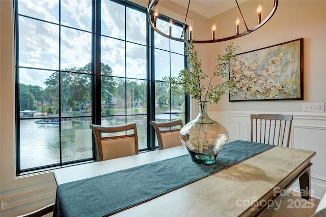445 Sundown Rd, Mooresville, NC 28117 - dining space with a chandelier, a wainscoted wall, and a decorative wall