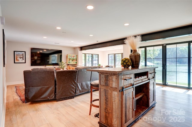 445 Sundown Rd, Mooresville, NC 28117 - kitchen featuring light wood-type flooring, plenty of natural light, a breakfast bar, and recessed lighting