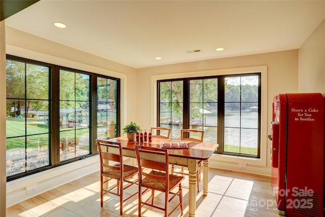 445 Sundown Rd, Mooresville, NC 28117 - dining space with recessed lighting, light wood finished floors, a water view, and baseboards