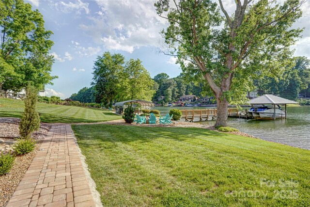 445 Sundown Rd, Mooresville, NC 28117 - view of grassy yard featuring a water view, a detached carport, and a dock