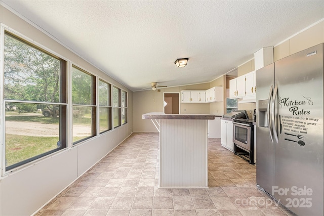 3585 Woodstream Dr, Maiden, NC 28650 - kitchen with appliances with stainless steel finishes, ceiling fan, a textured ceiling, dark countertops, and a kitchen island