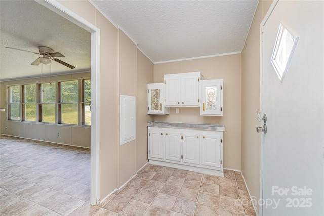3585 Woodstream Dr, Maiden, NC 28650 - kitchen featuring a textured ceiling, white cabinets, a ceiling fan, baseboards, and light countertops