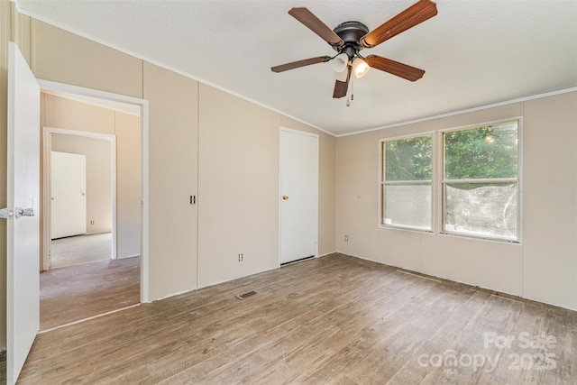 3585 Woodstream Dr, Maiden, NC 28650 - spare room featuring light wood-style flooring, ornamental molding, ceiling fan, and lofted ceiling