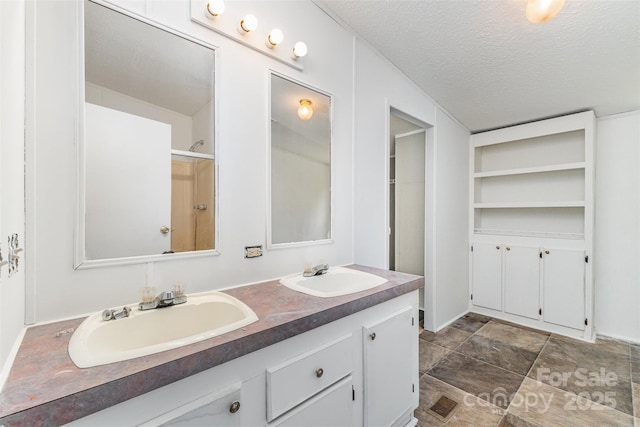 3585 Woodstream Dr, Maiden, NC 28650 - bathroom with double vanity, a textured ceiling, stone finish floors, and a shower