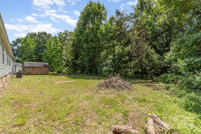 3585 Woodstream Dr, Maiden, NC 28650 - view of green lawn featuring central AC unit and an outbuilding