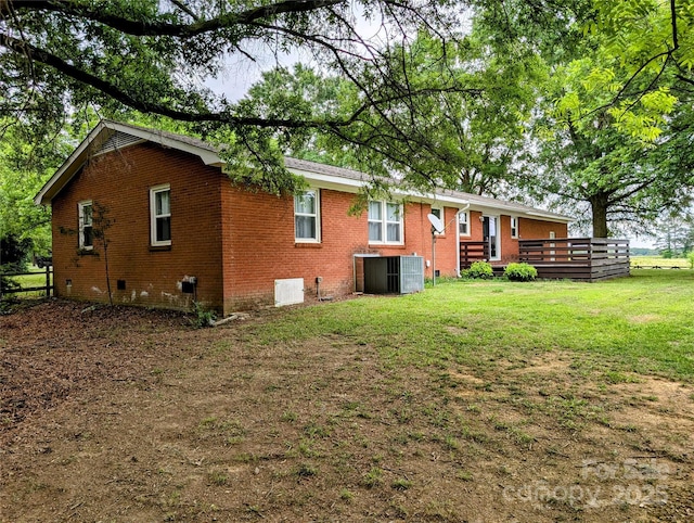 5628 White Store Rd, Wingate, NC 28174 - back of property featuring brick siding, crawl space, a yard, central air condition unit, and a wooden deck