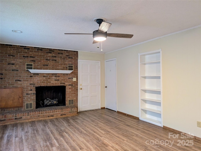 5628 White Store Rd, Wingate, NC 28174 - unfurnished living room featuring baseboards, wood finished floors, a ceiling fan, built in shelves, and a textured ceiling