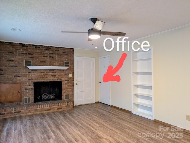 5628 White Store Rd, Wingate, NC 28174 - unfurnished living room with a ceiling fan, baseboards, wood finished floors, built in features, and ornamental molding