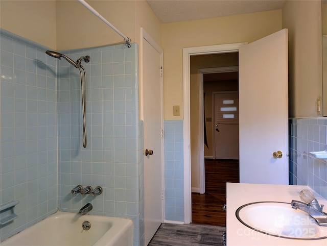 5628 White Store Rd, Wingate, NC 28174 - full bath featuring shower / bath combination, wood finished floors, tile walls, a wainscoted wall, and vanity