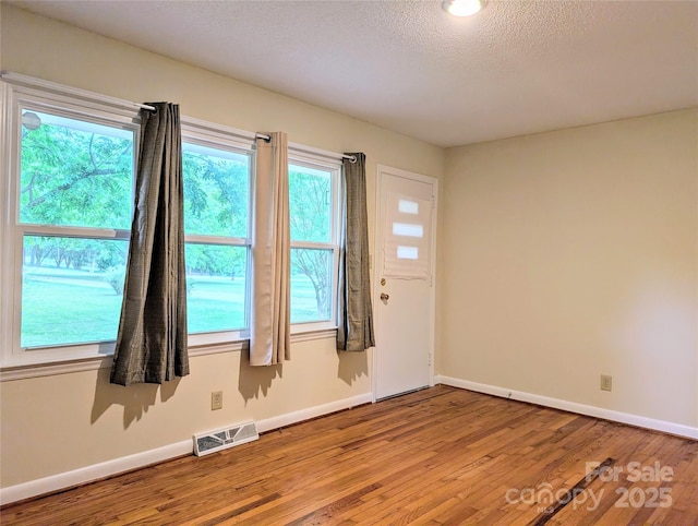 5628 White Store Rd, Wingate, NC 28174 - entrance foyer featuring wood finished floors, baseboards, and a textured ceiling