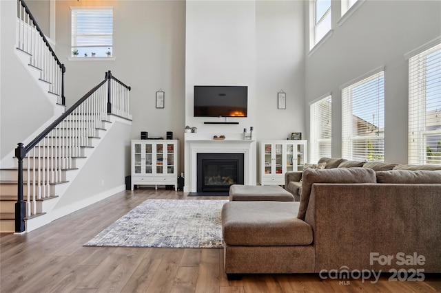 1478 Imperial Ct, York, SC 29745 - living area featuring a towering ceiling, plenty of natural light, wood finished floors, stairs, and baseboards