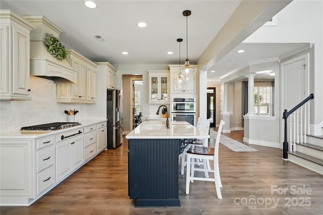 1478 Imperial Ct, York, SC 29745 - kitchen with stainless steel appliances, cream cabinetry, a sink, tasteful backsplash, and light countertops