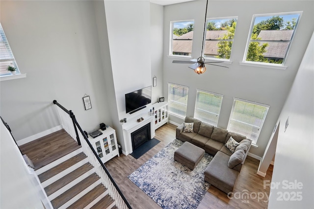 1478 Imperial Ct, York, SC 29745 - living area with a high ceiling, baseboards, ceiling fan, a fireplace with flush hearth, and wood finished floors