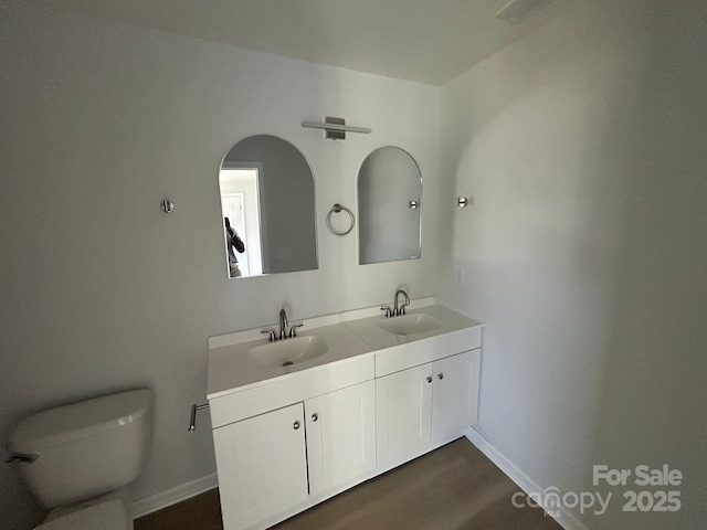 360 Ledbetter Rd, Spindale, NC 28160 - full bathroom with double vanity, toilet, wood finished floors, and baseboards