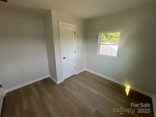 360 Ledbetter Rd, Spindale, NC 28160 - unfurnished bedroom featuring dark wood-style floors and baseboards