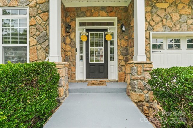 5021 Meadow Woods Dr, Lowell, NC 28098 - view of exterior entry featuring stone siding and covered porch