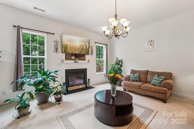 5021 Meadow Woods Dr, Lowell, NC 28098 - living area with carpet flooring, a chandelier, and a fireplace with flush hearth