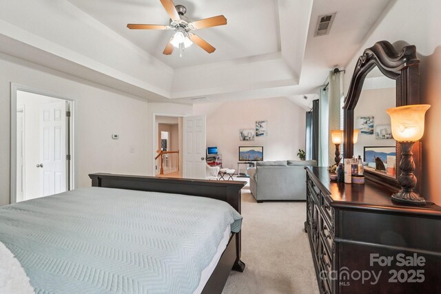 5021 Meadow Woods Dr, Lowell, NC 28098 - bedroom with light carpet, a tray ceiling, and a ceiling fan