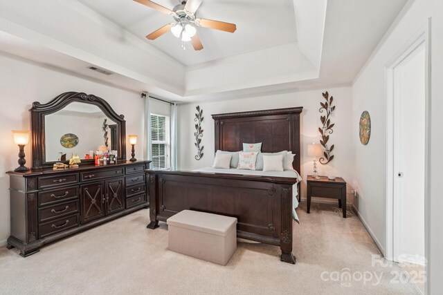 5021 Meadow Woods Dr, Lowell, NC 28098 - bedroom featuring light carpet, a raised ceiling, and ceiling fan