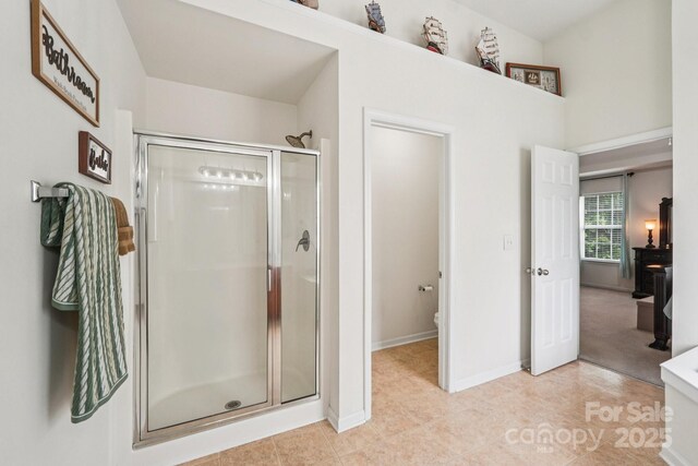 5021 Meadow Woods Dr, Lowell, NC 28098 - bathroom with a shower stall, baseboards, tile patterned flooring, and toilet