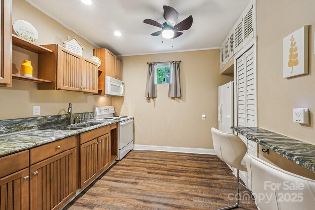 5021 Meadow Woods Dr, Lowell, NC 28098 - kitchen with white appliances, a sink, open shelves, dark wood-style floors, and baseboards