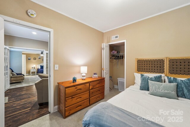 5021 Meadow Woods Dr, Lowell, NC 28098 - bedroom with ornamental molding, a spacious closet, baseboards, and carpet