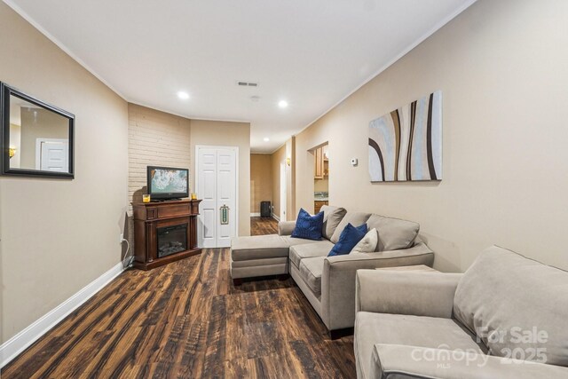 5021 Meadow Woods Dr, Lowell, NC 28098 - living room with dark wood finished floors, baseboards, recessed lighting, crown molding, and a glass covered fireplace