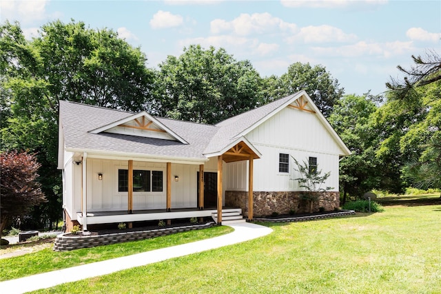 8340 Brief Rd, Mint Hill, NC 28227 - modern inspired farmhouse with a shingled roof, a porch, board and batten siding, a front yard, and stone siding