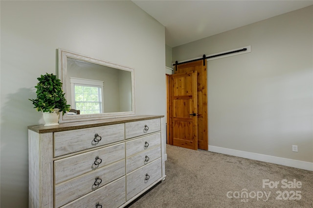 8340 Brief Rd, Mint Hill, NC 28227 - bedroom featuring a barn door, carpet floors, and baseboards