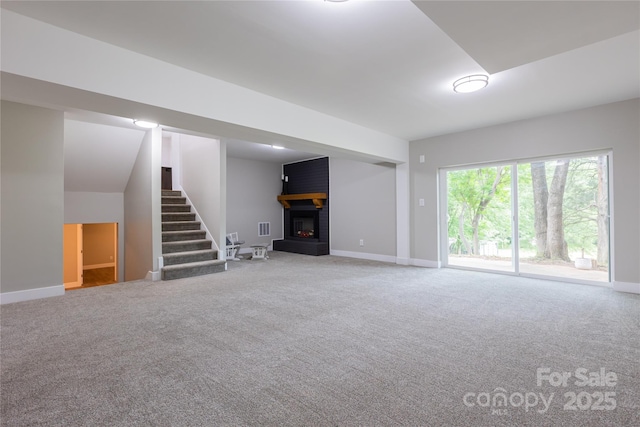8340 Brief Rd, Mint Hill, NC 28227 - unfurnished living room featuring a fireplace, carpet, stairs, and baseboards