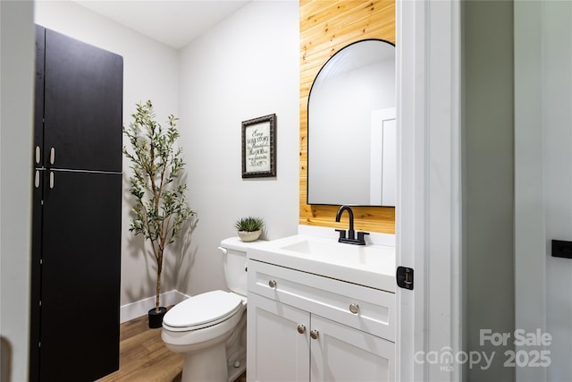 8340 Brief Rd, Mint Hill, NC 28227 - bathroom featuring vanity, toilet, wood finished floors, and baseboards