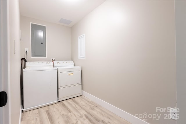 8340 Brief Rd, Mint Hill, NC 28227 - laundry room featuring washing machine and dryer, electric panel, light wood-type flooring, and baseboards