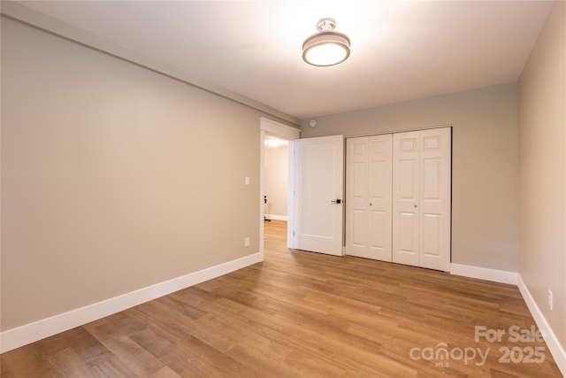 8340 Brief Rd, Mint Hill, NC 28227 - unfurnished bedroom with baseboards, light wood-style flooring, and a closet