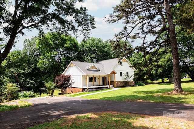 8340 Brief Rd, Mint Hill, NC 28227 - view of front of property with a front yard, covered porch, and asphalt driveway