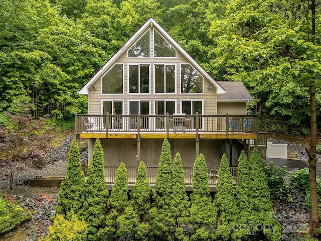 350 Mckissick Rd, Flat Rock, NC 28731 - rear view of house with a wooden deck, stucco siding, and a wooded view