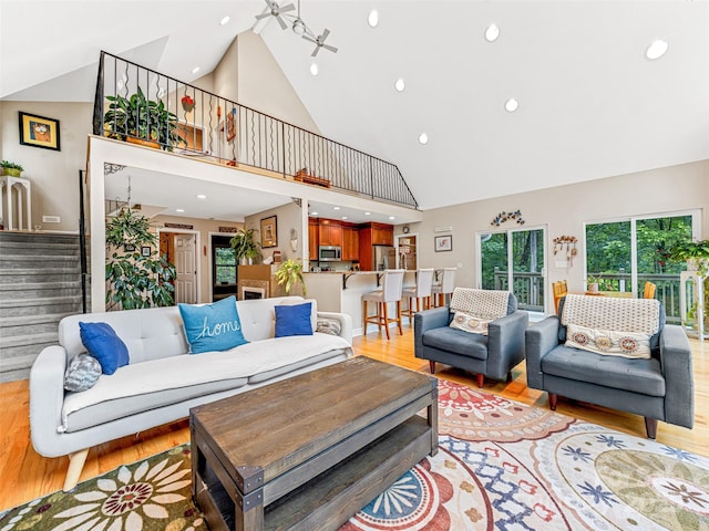 350 Mckissick Rd, Flat Rock, NC 28731 - living area featuring high vaulted ceiling, stairs, light wood-style flooring, and recessed lighting