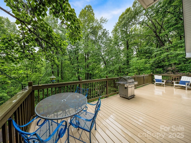 350 Mckissick Rd, Flat Rock, NC 28731 - deck featuring a grill, outdoor dining space, and view of wooded area