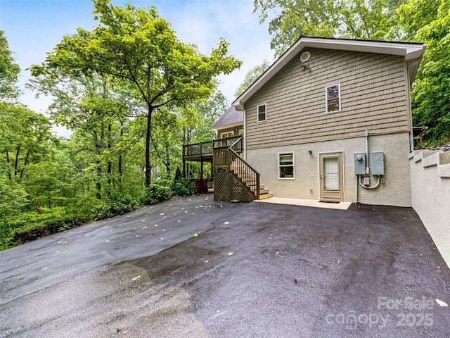 350 Mckissick Rd, Flat Rock, NC 28731 - rear view of property featuring stairway, stucco siding, a patio area, and a wooden deck