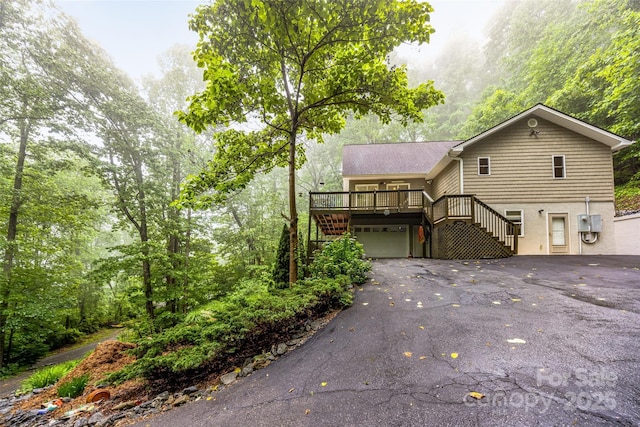 350 Mckissick Rd, Flat Rock, NC 28731 - view of front of house featuring stairs, driveway, a wooden deck, and a garage