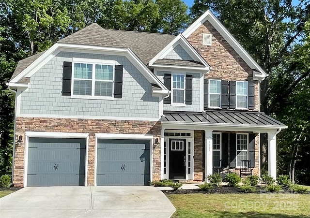 5005 Blue Serenity Ct, Denver, NC 28037 - view of front of house with stone siding, an attached garage, driveway, a standing seam roof, and roof with shingles