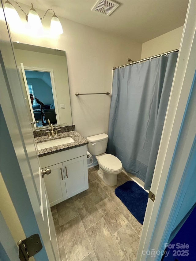 5005 Blue Serenity Ct, Denver, NC 28037 - bathroom with vanity, toilet, a shower with shower curtain, stone finish floors, and connected bathroom