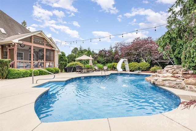 6057 Erie View Ct, Denver, NC 28037 - swimming pool featuring a sunroom, a water slide, a patio area, and ceiling fan
