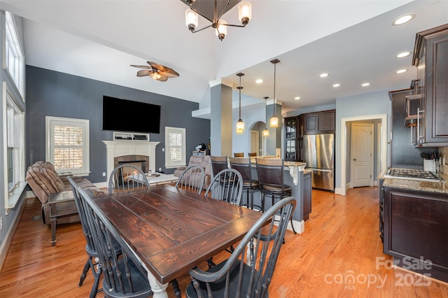 6057 Erie View Ct, Denver, NC 28037 - dining room with ceiling fan, light wood finished floors, a fireplace, baseboards, and recessed lighting