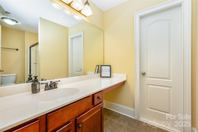 6057 Erie View Ct, Denver, NC 28037 - bathroom featuring vanity, tile patterned flooring, toilet, baseboards, and a shower with door
