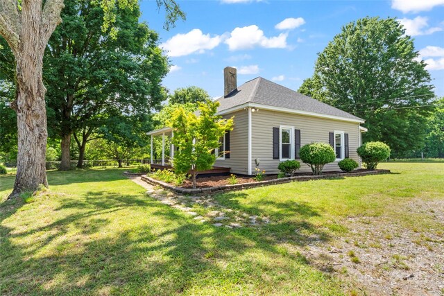 233 Sellars Rd, Kings Mountain, NC 28086 - view of home's exterior with a chimney and a lawn