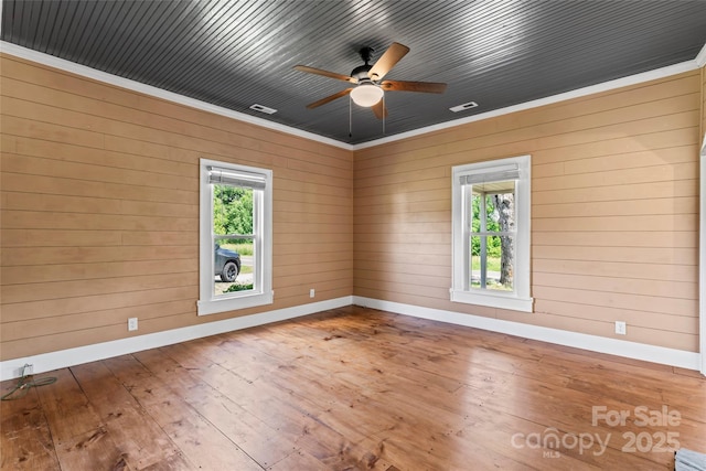 233 Sellars Rd, Kings Mountain, NC 28086 - spare room with baseboards, healthy amount of natural light, hardwood / wood-style floors, ceiling fan, and wood walls