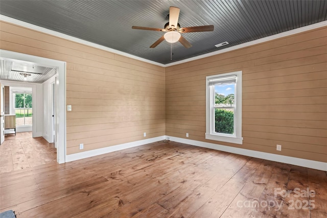 233 Sellars Rd, Kings Mountain, NC 28086 - unfurnished room with hardwood / wood-style floors, ceiling fan, wooden walls, baseboards, and crown molding